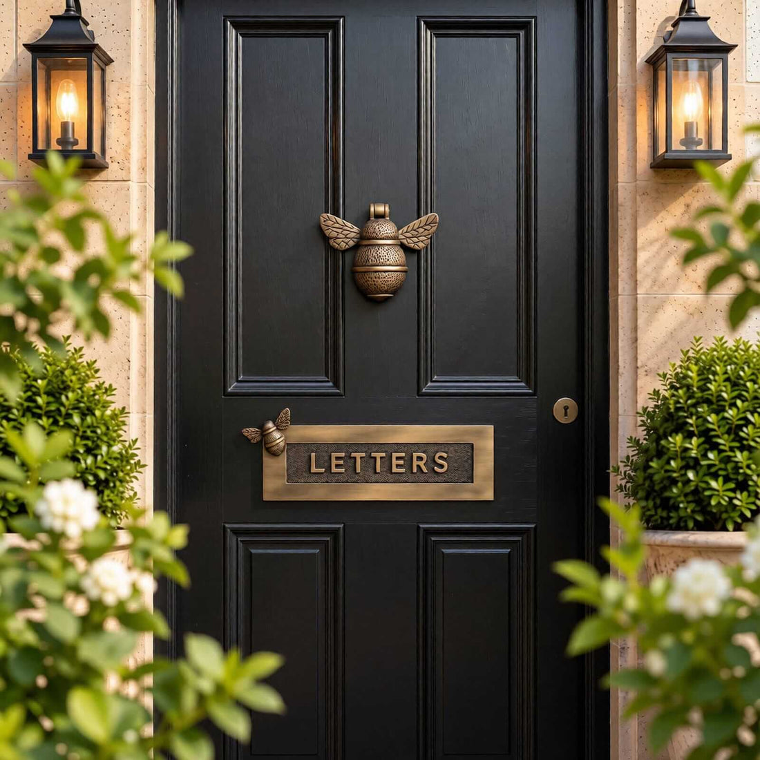 Polished brass bumble bee door knocker and bee LETTERS letter box plate fitted to a dark panelled front door