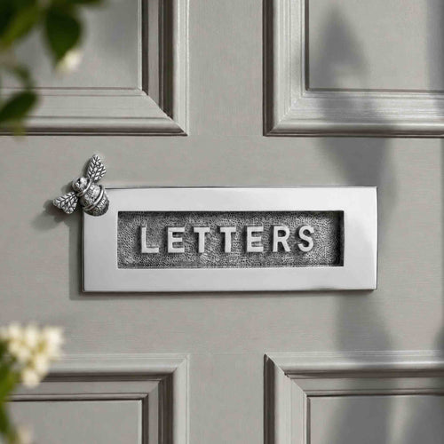 Polished chrome Bumble Bee "LETTERS" letter plate fitted to a grey panelled front door