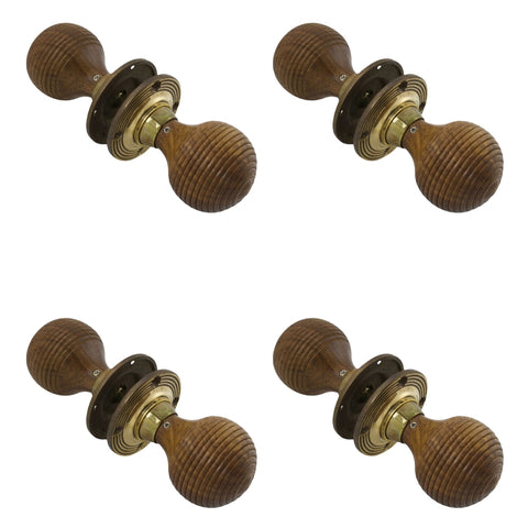 Four pairs of rosewood beehive door knobs with aged brass backplates arranged in rows.
