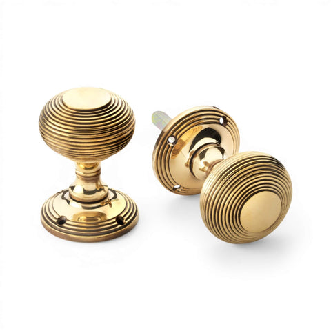 55mm aged brass beehive mortice door knobs pair with reeded design on backplate