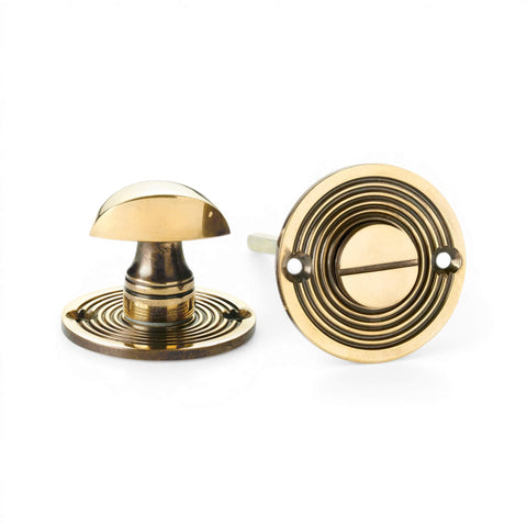 Beehive bathroom thumb turn and release in aged brass finish with circular rose
