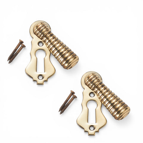 Beehive escutcheon and matching solid brass keyhole cover with fixing screws in aged brass finish