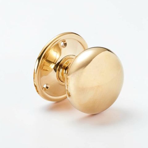 Polished brass cottage door knob side angle showing profile and finish