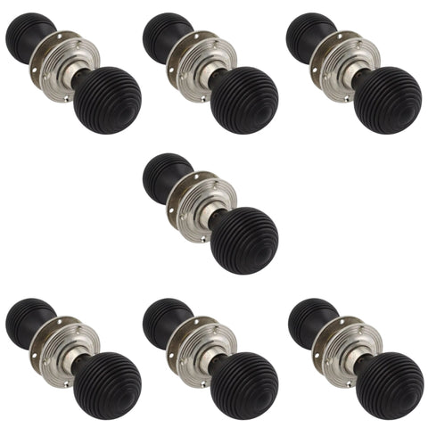 Set of seven pairs of ebonised and polished nickel beehive door knobs arranged on a white background.