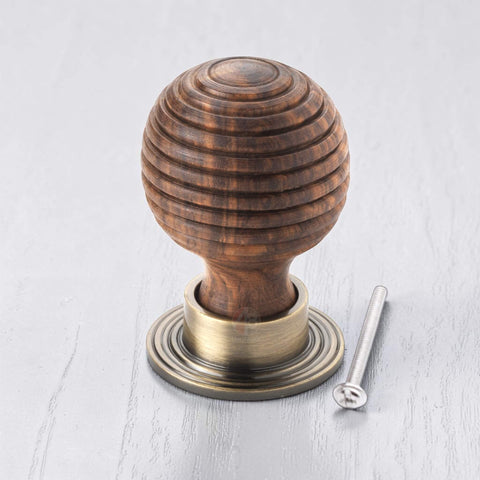 Large rosewood beehive wooden cupboard knob with antique brass backplate and fixing bolt
