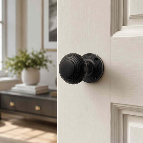 Black Sprung Beehive Mortice Door Knob Installed on a White Internal Door in a Contemporary Home