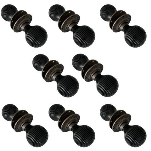 Set of eight pairs of ebonised beehive door knobs with matt antique backplates displayed on a white background.