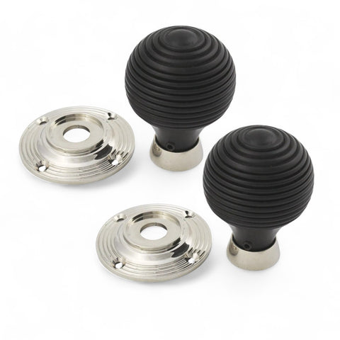 Pair of ebonised beehive door knobs with polished nickel backplates displayed on a white background.