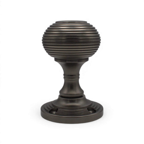 Single pewter beehive mortice door knob upright, showing textured ribbed detailing and round backplate.