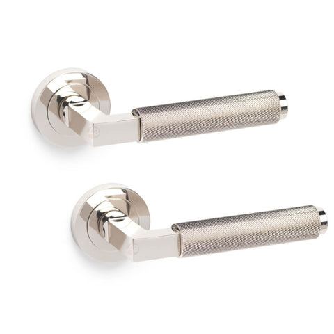 Pair of polished nickel knurled internal door handles on round roses displayed against a white background, supplied as a matching handle set.