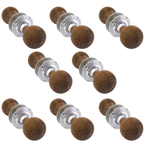 Set of eight pairs of rosewood and polished chrome beehive door knobs arranged together