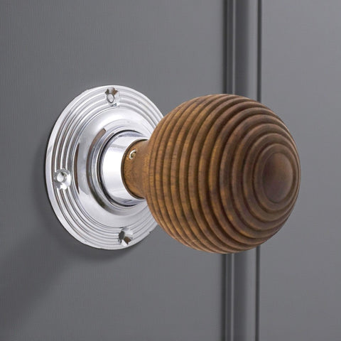 Rosewood beehive door knob with polished chrome backplate fitted to a grey door