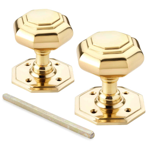 Pair of polished brass octagonal door knobs supplied with mortice spindle