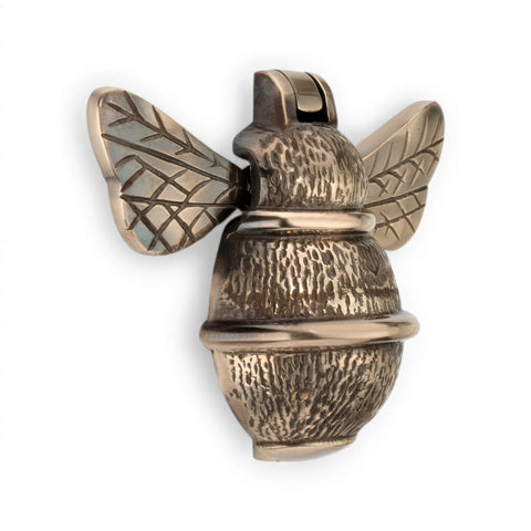 Unlacquered aged brass bumble bee door knocker, front view showing textured body and detailed wings.
