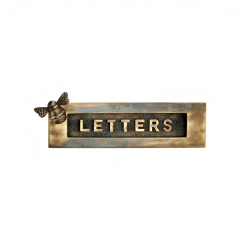 Front view of an aged brass bumble bee letter plate with raised “LETTERS” wording.