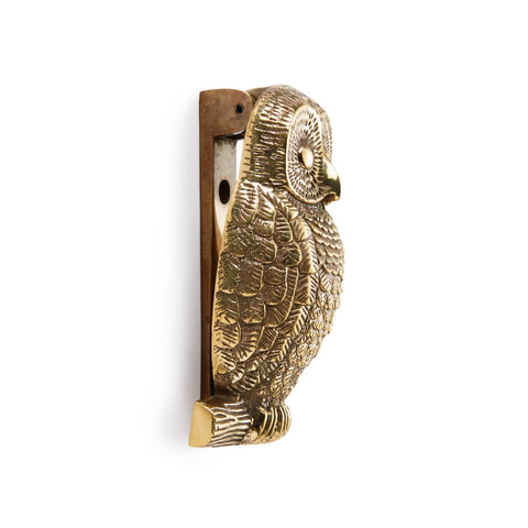 Side profile of unlacquered aged brass owl door knocker showing raised feather detailing