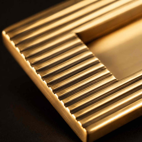 Macro close-up of reeded detailing on unlacquered aged brass solid brass letter plate