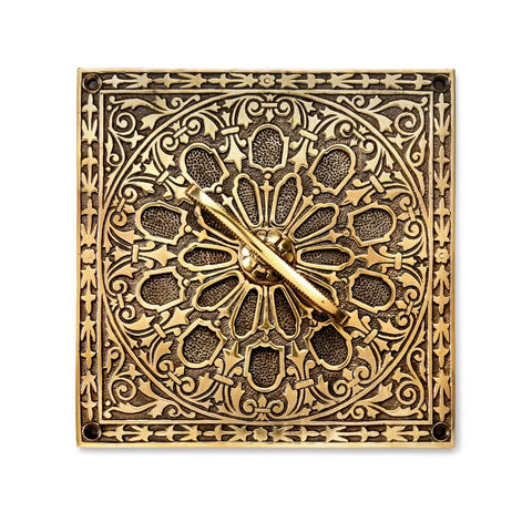 Decorative aged brass square air vent with ornate Victorian-style floral pattern and integrated sliding vent control.