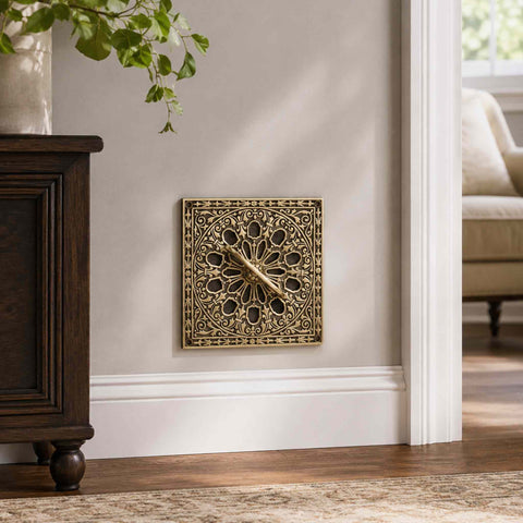 Aged brass square air vent installed on an interior wall, showcasing the decorative design and traditional period styling.