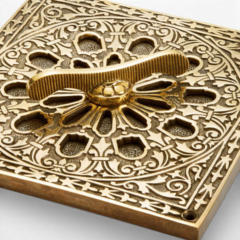 Detailed close-up of the aged brass vent control and floral centrepiece, emphasising the craftsmanship and aged brass patina.