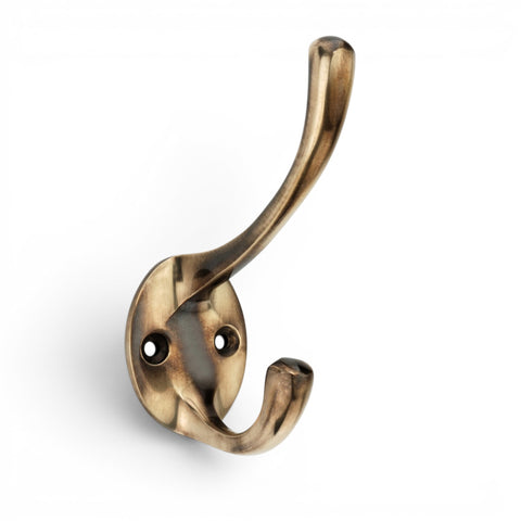 Solid brass Victorian double coat hook in an unlacquered aged brass finish