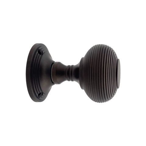 Side profile of aged bronze beehive mortice door knob showing ribbed detailing