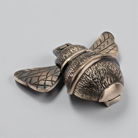 Unlacquered aged brass bumble bee door knocker angled view highlighting warm aged finish and wing detail