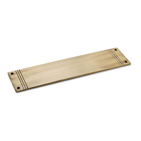 Solid brass reeded push plate in antique brass finish, 305mm x 75mm, angled view showing stepped detailing