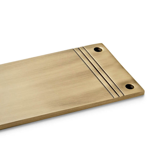 Close-up of reeded detailing on solid brass push plate in antique brass finish with countersunk fixing holes