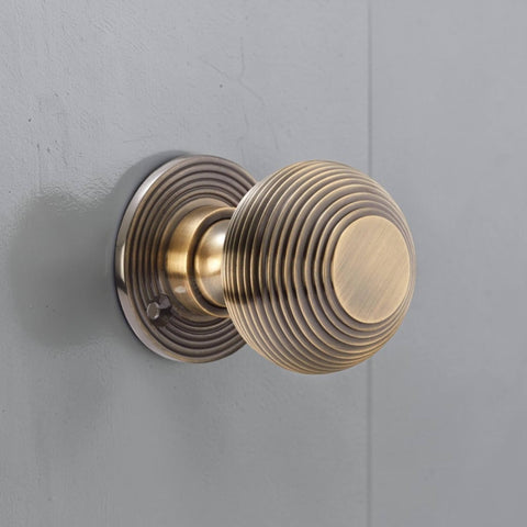 Antique Brass Beehive Door Knob Installed on Grey Door