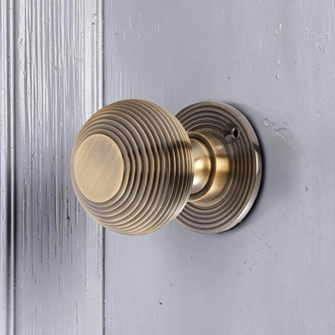 Side View of Antique Brass Beehive Mortice Door Knob on Painted Door
