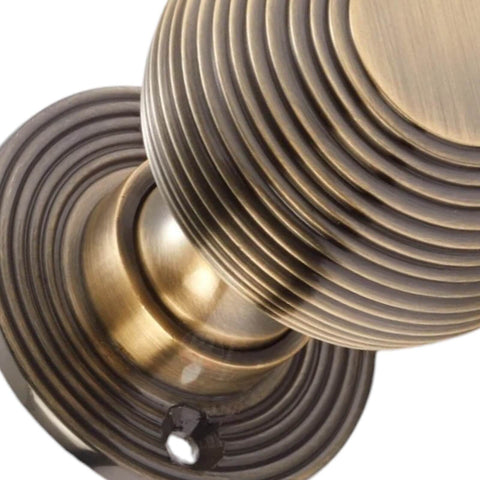 Close Up of Reeded Antique Brass Beehive Door Knob Detail
