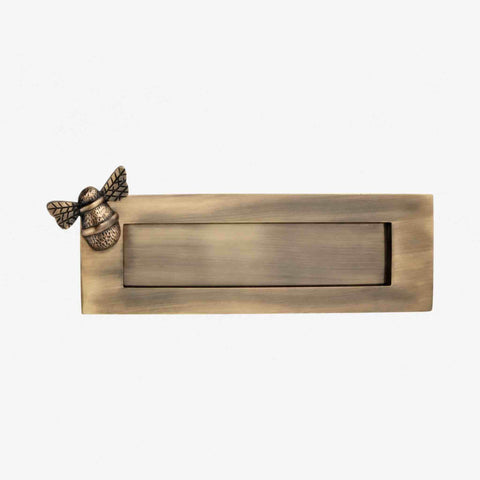 Front view of antique brass bumble bee letter plate with plain flap and traditional aged finish