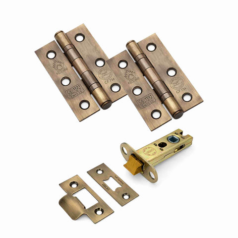 Antique brass complete door kit with pair of CE7 ball bearing hinges, heavy-duty 3-inch tubular latch and matching strike plates.