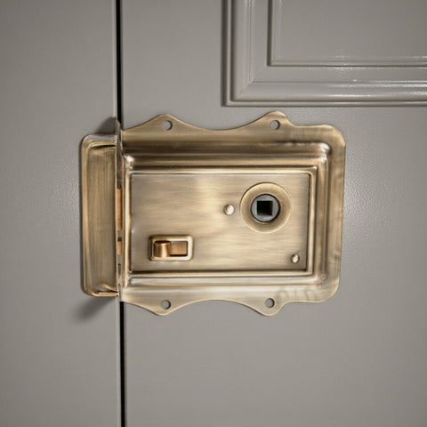 Close-up of antique brass Victorian rim lock showing snib and flanged detailing