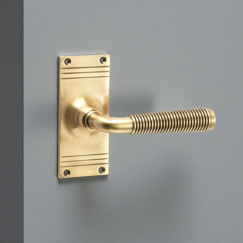 Antique brass reeded lever on backplate fitted to painted internal door