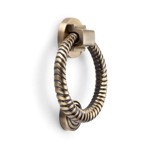 Antique brass reeded ring door knocker angled product view on a white background