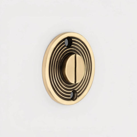 Close-Up of Aged Brass Beehive Emergency Coin Release on Reeded Backplate