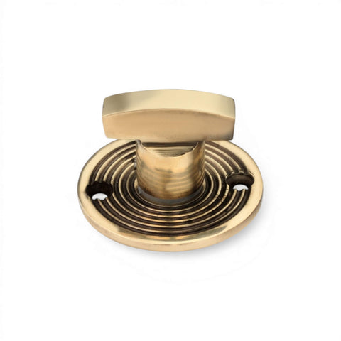 Front View of Aged Brass Beehive Thumb Turn with Traditional Reeded Backplate