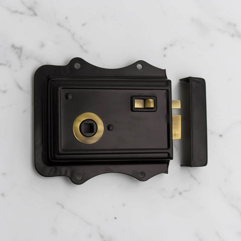 Complete black and antique brass Victorian rim lock set with matching keep and fixing screws.