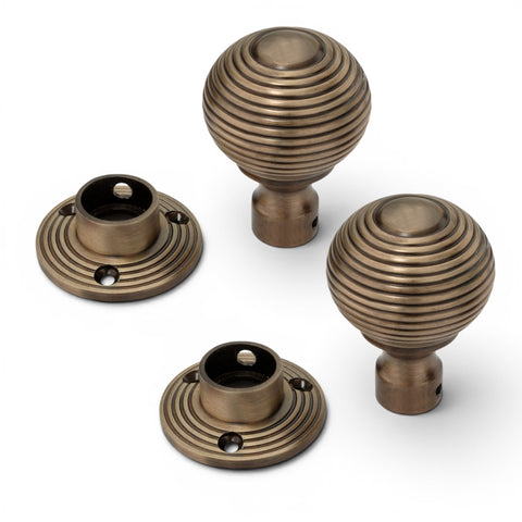 Antique brass beehive door knob pair with removable reeded backplates showing fixing points