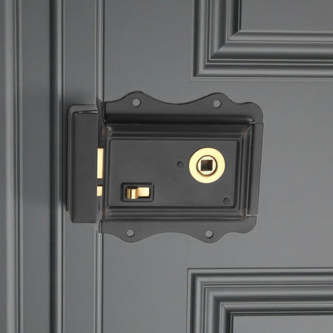Olde Victorian style rim lock in matte black with polished brass latch shown fitted to door