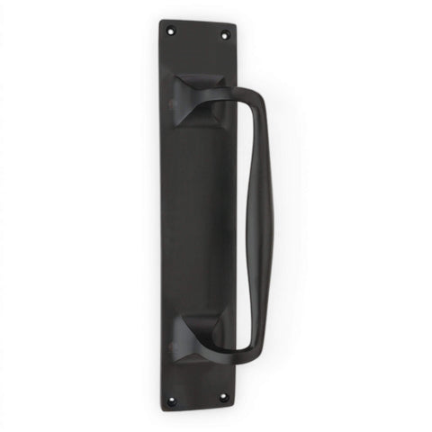 Black cast iron door pull handle on rectangular backplate, vertical position with four visible fixing holes.
