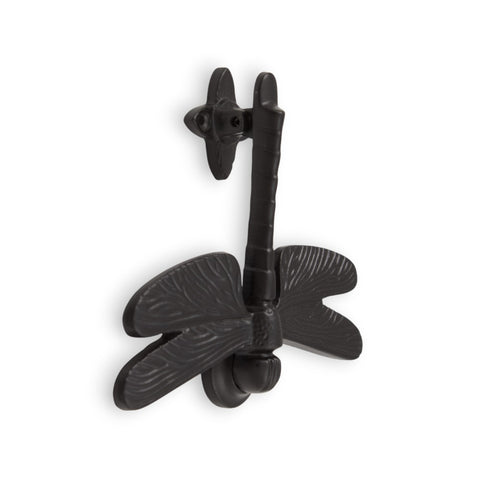 Black cast iron dragonfly door knocker on a white background.