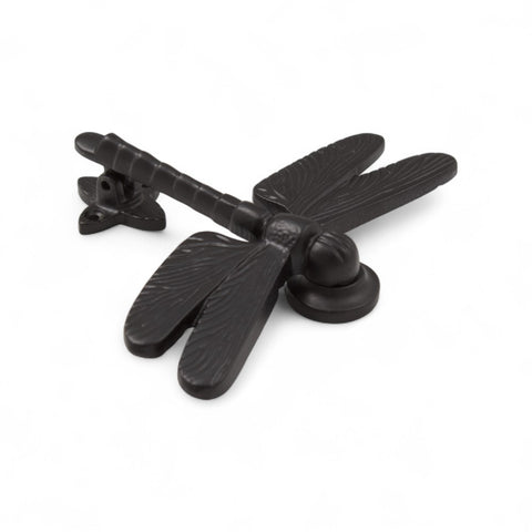 Black cast iron dragonfly door knocker showing detailed wing design.
