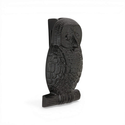 Black cast iron owl door knocker side view showing detailed feather design and branch base.