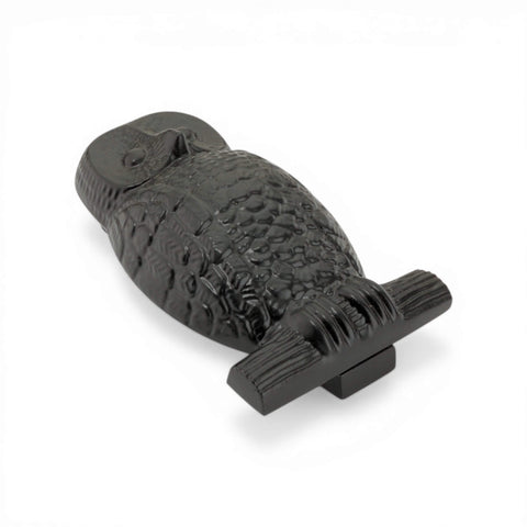 Black cast iron owl door knocker angled view showing raised owl design and solid base.
