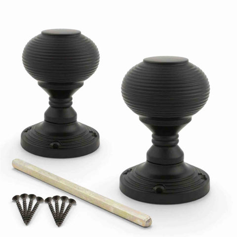 Pair of black sprung beehive mortice door knobs with spindle and matching fixing screws