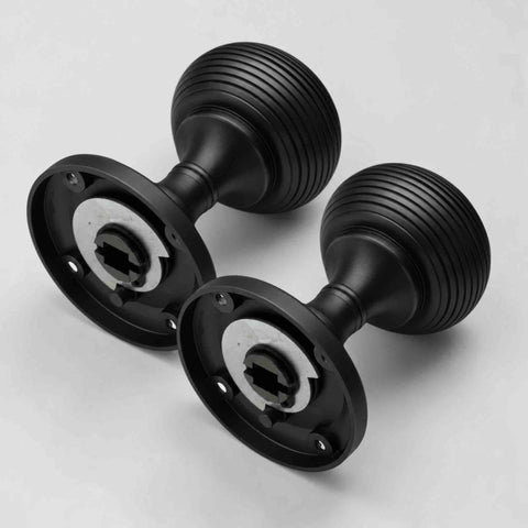 Rear view of black sprung beehive door knobs showing the internal sprung mechanism