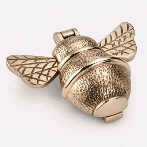 Polished brass bumble bee door knocker shown closed with decorative wing detailing